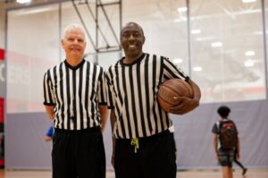 image of sports officials standing with basketball