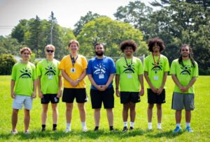 image of group of youth sports staff posed on a field.