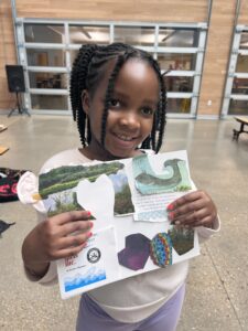 Child posed with art project