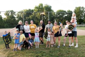 picture of Kickball team with families at Centennial party