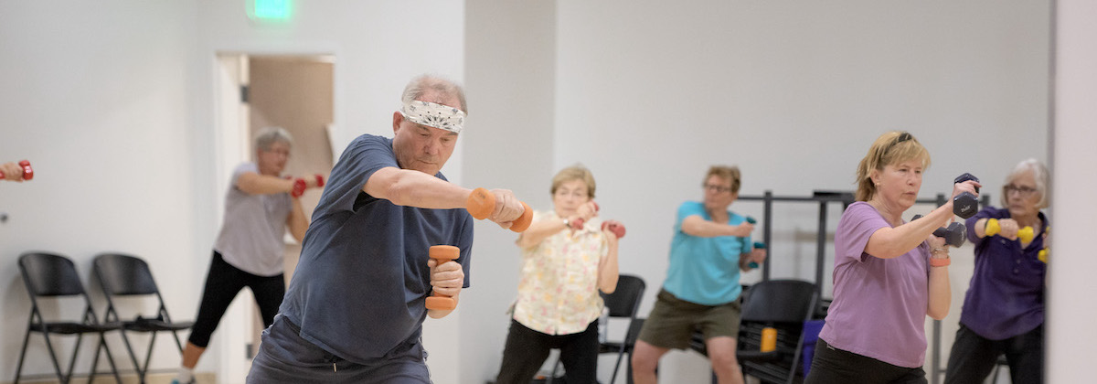 A group of older adults sweating it out in a fitness class