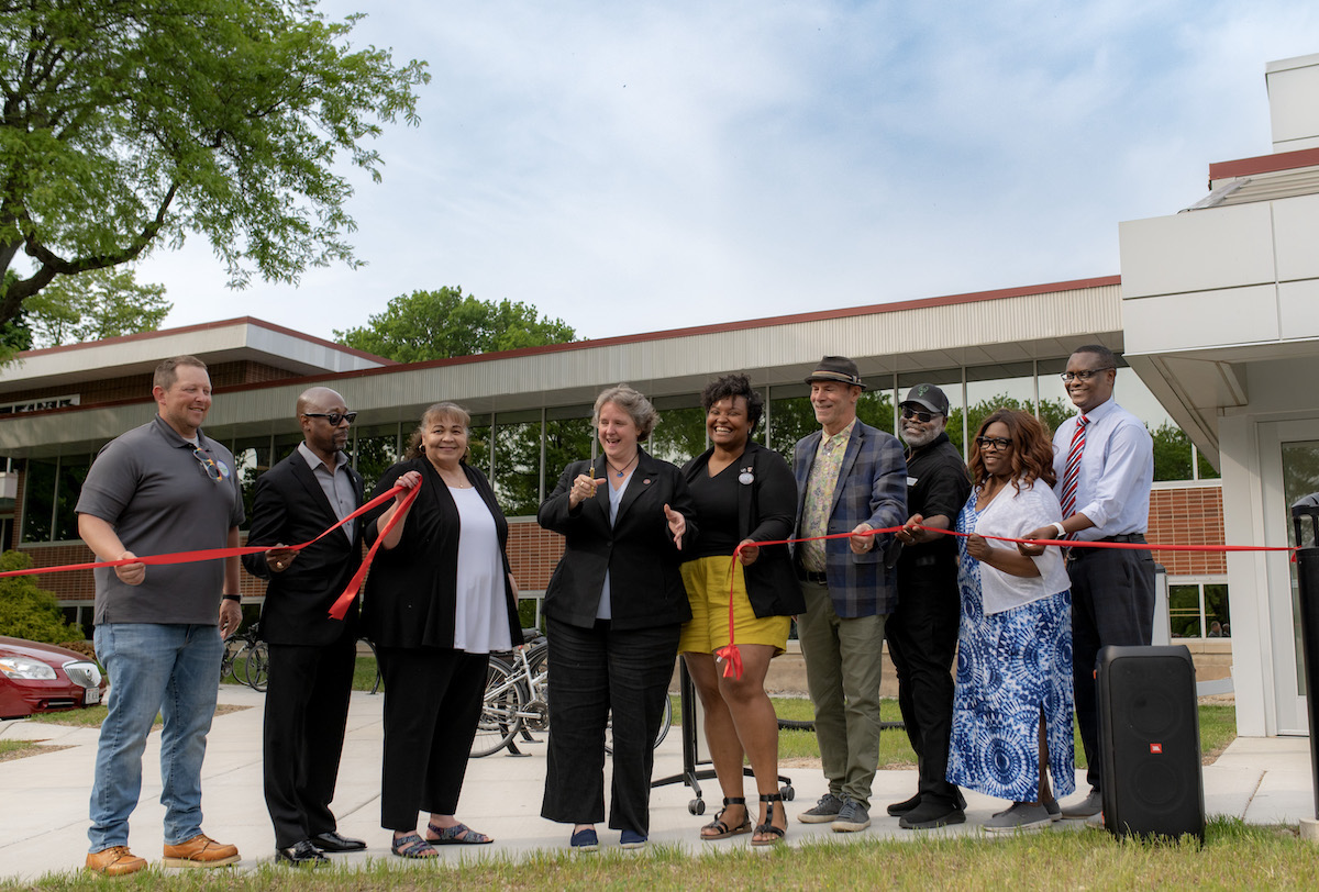 A team of adults cutting the ribbon that marks the official opening of the new MSCR facility.