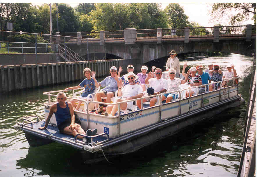 people on a pontoon boat in the water