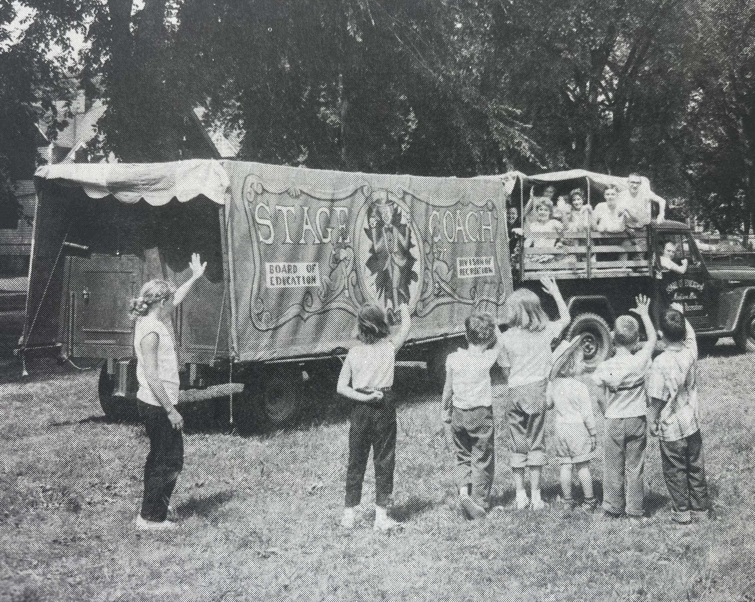 picture of childen acting outside in front of a truck